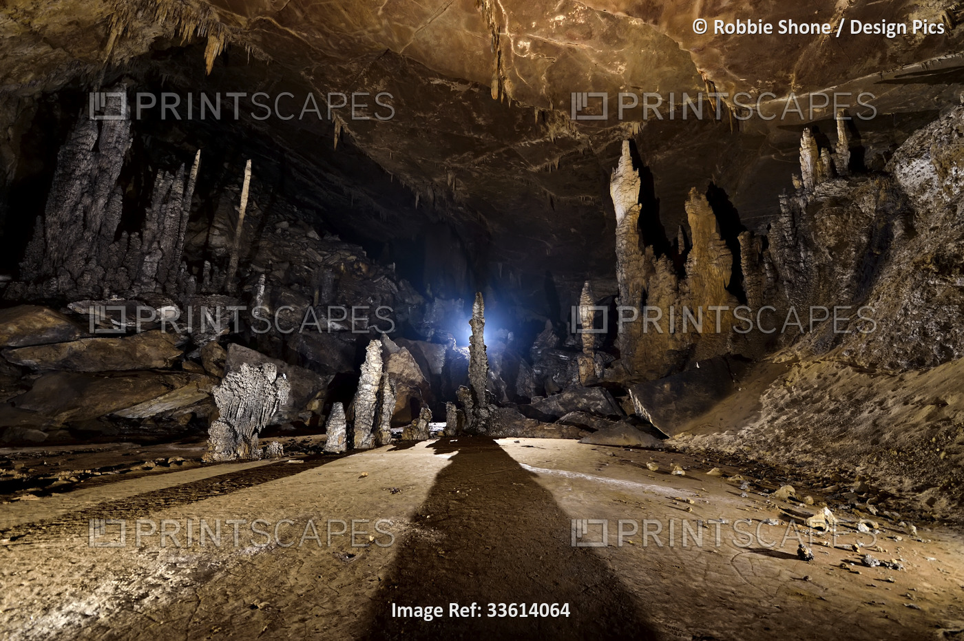 Tall stalagmites overlook a field of sediments in San Wang Dong.; Wulong, ...