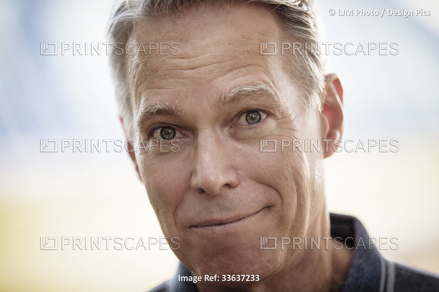 Close-up portrait of handsome senior man with greying hair; Edmonton, Alberta, ...
