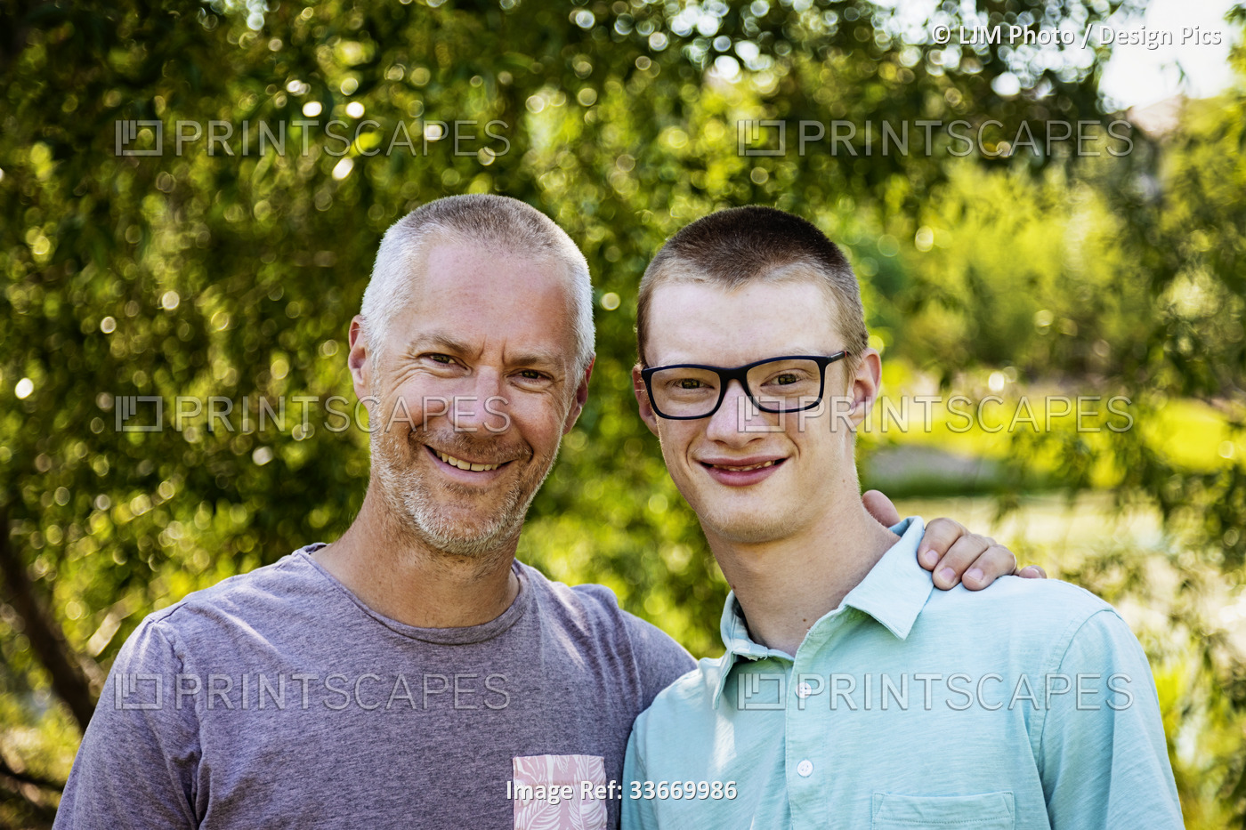Outdoor portrait of a father with his young adult son; Edmonton, Alberta, Canada