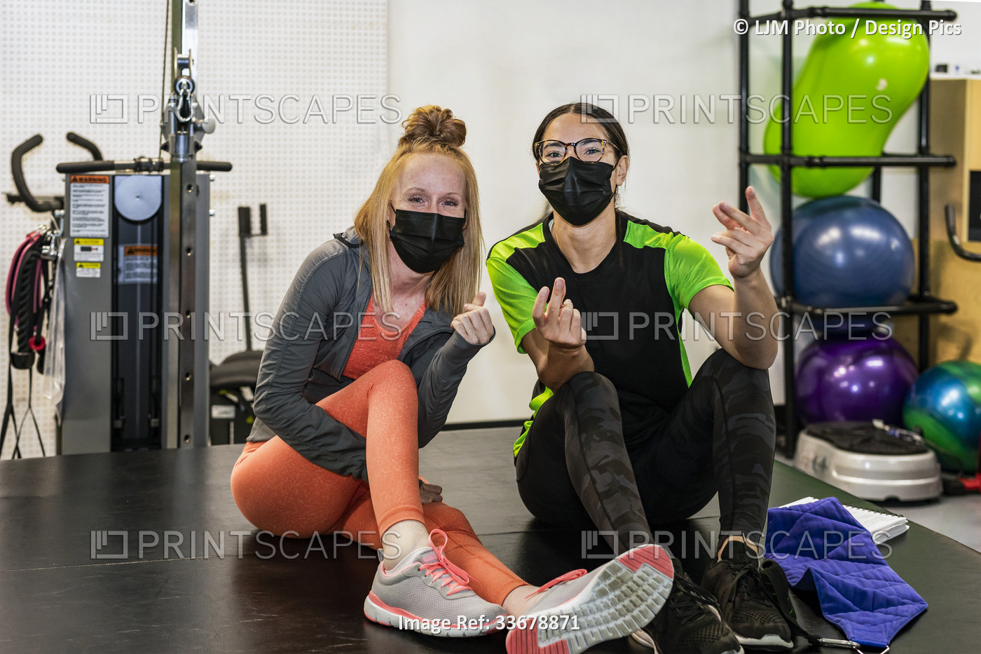 A paraplegic woman and trainer celebrating the day's accomplishment by clicking ...