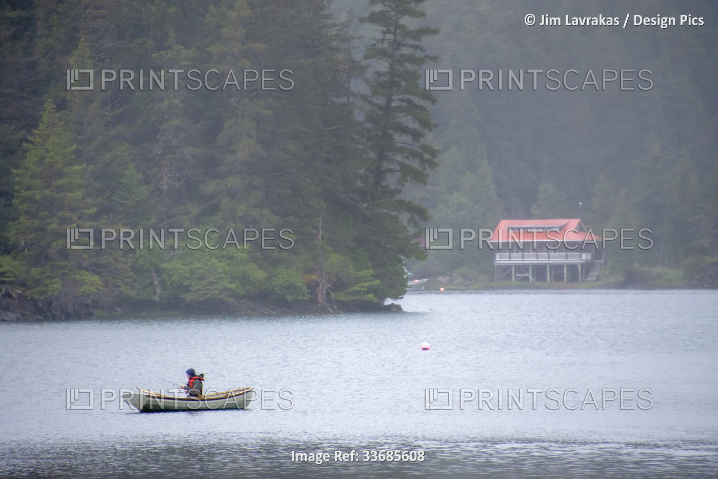 A local man fishes from a small skiff in Little Tutka Bay, across from Homer, ...