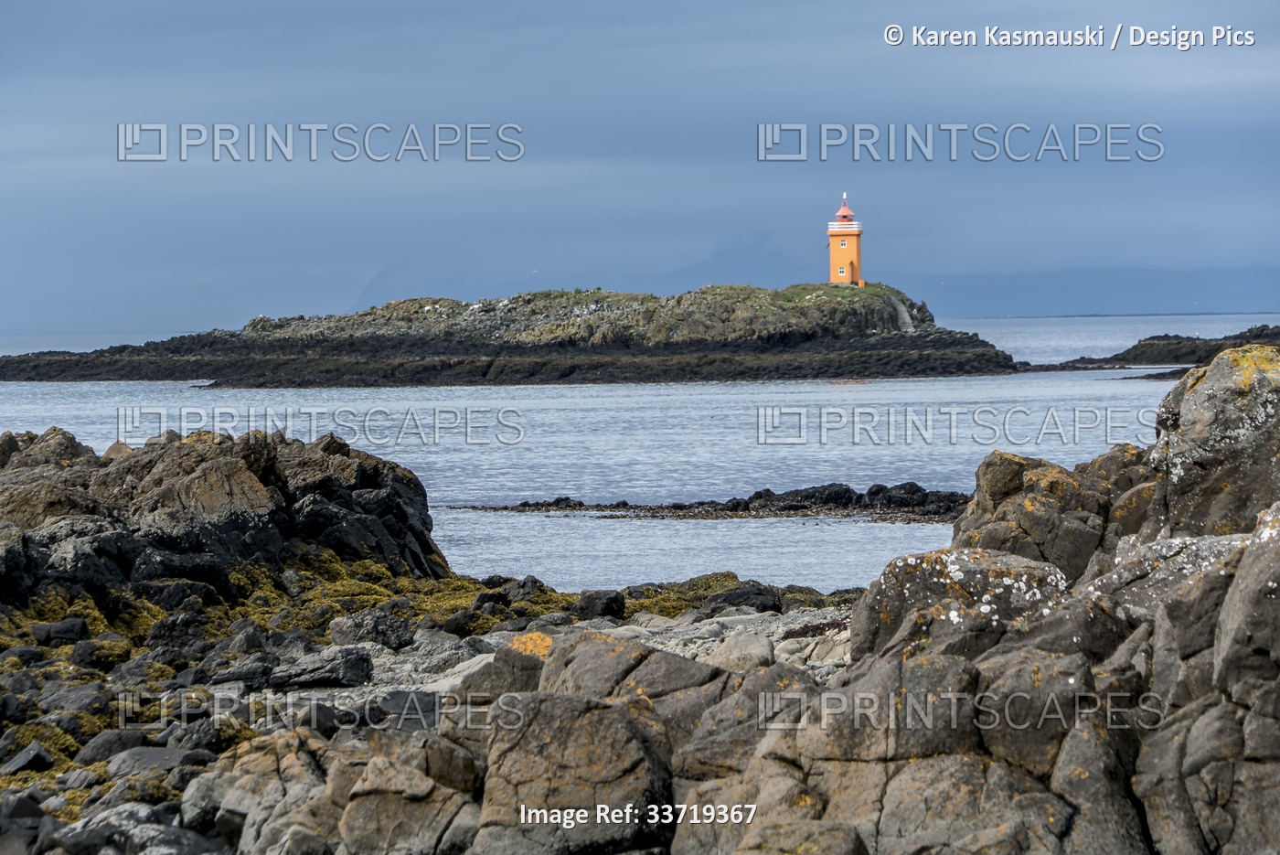 Lighthouse on the town of Flatey, Iceland, a former fishing village that is now ...