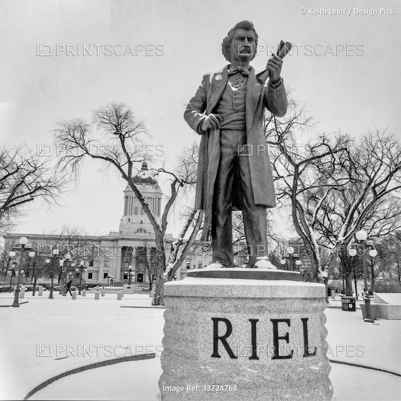 Statue of Louis Riel in front of the Manitoba Legislative Building in winter; ...