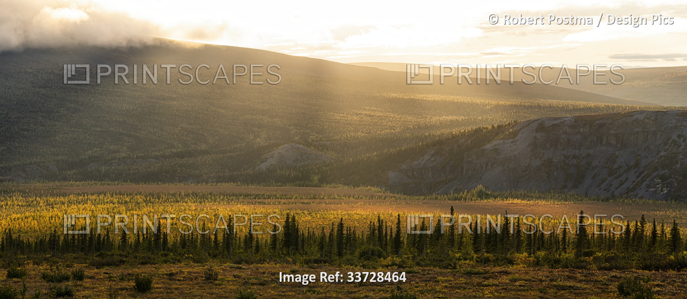 Beams of light at sunset near the arctic circle in the north of Yukon ...