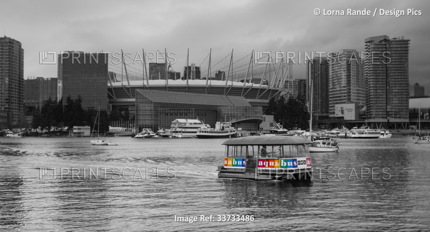 Black and white image of boats moored in a small harbour in False Creek with a ...