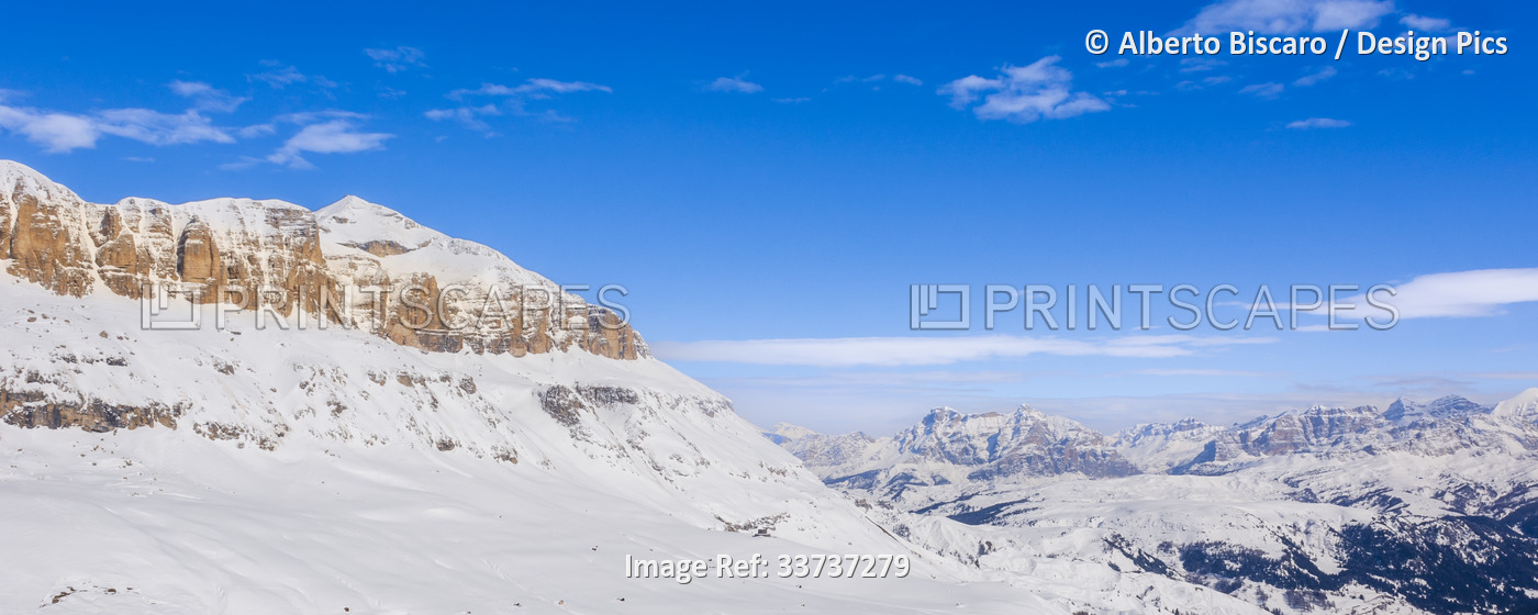 View of the snow covered mountain peaks and blue sky of the Sella Group in Val ...