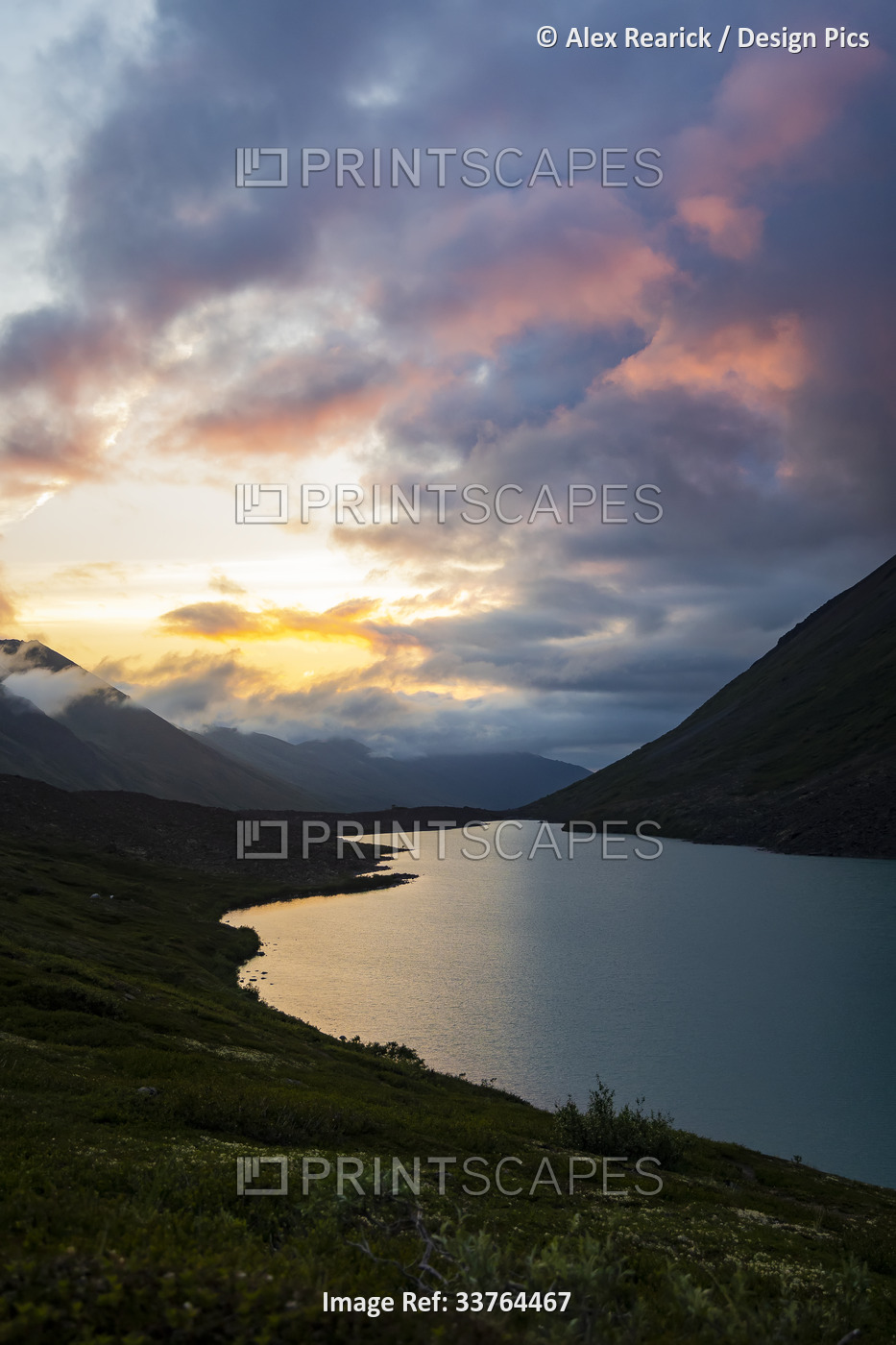 Dramatic sunset light glowing in clouds over Chugach State Park in Alaska, USA; ...