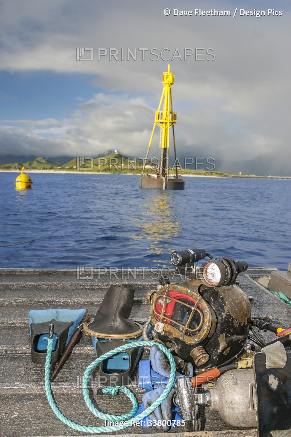 Commercial dive helmet and gear on the stern of a barge installing a massive ...