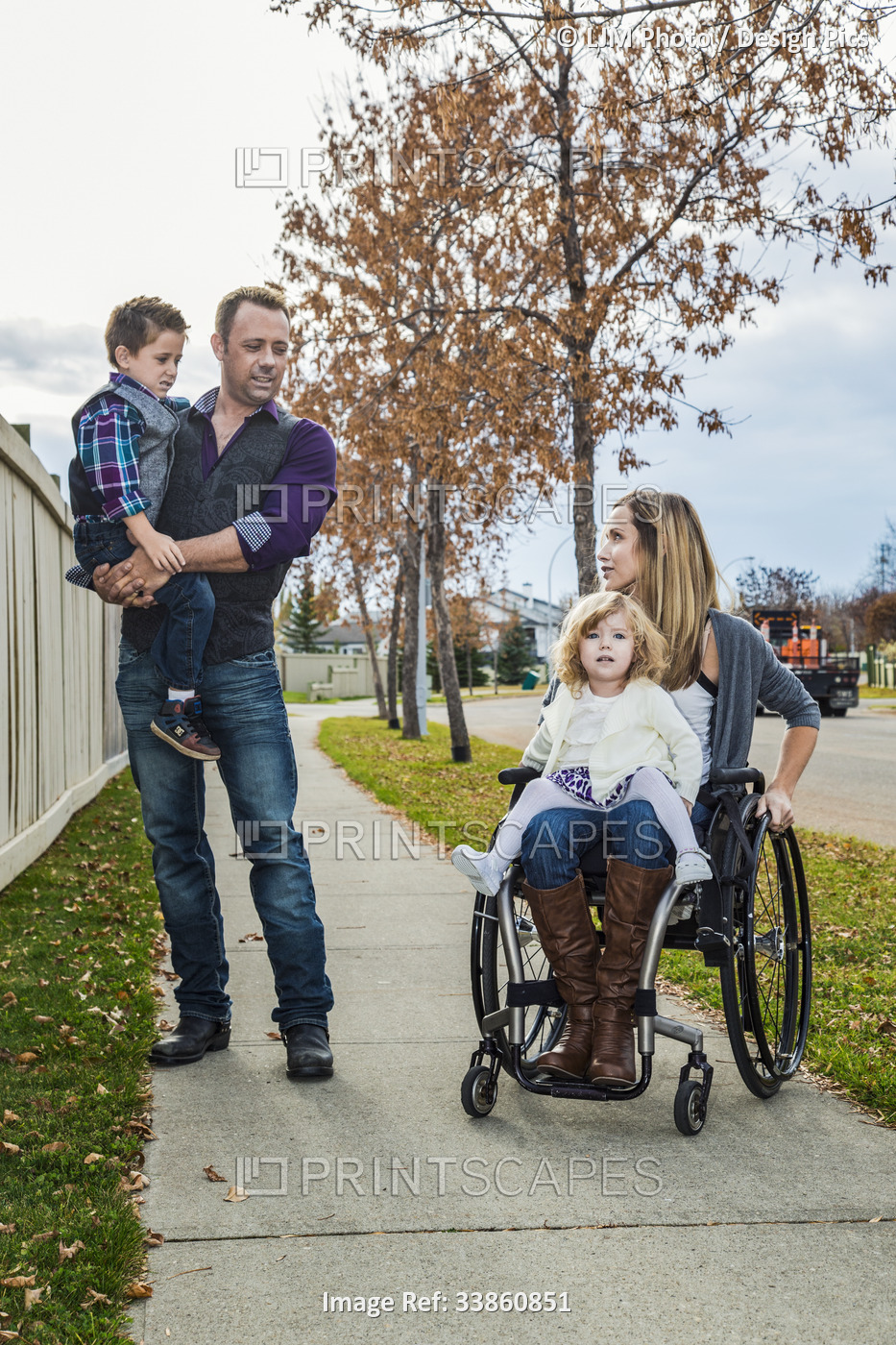 Disabled mother spending quality time with her family outdoors; Spruce Grove, ...
