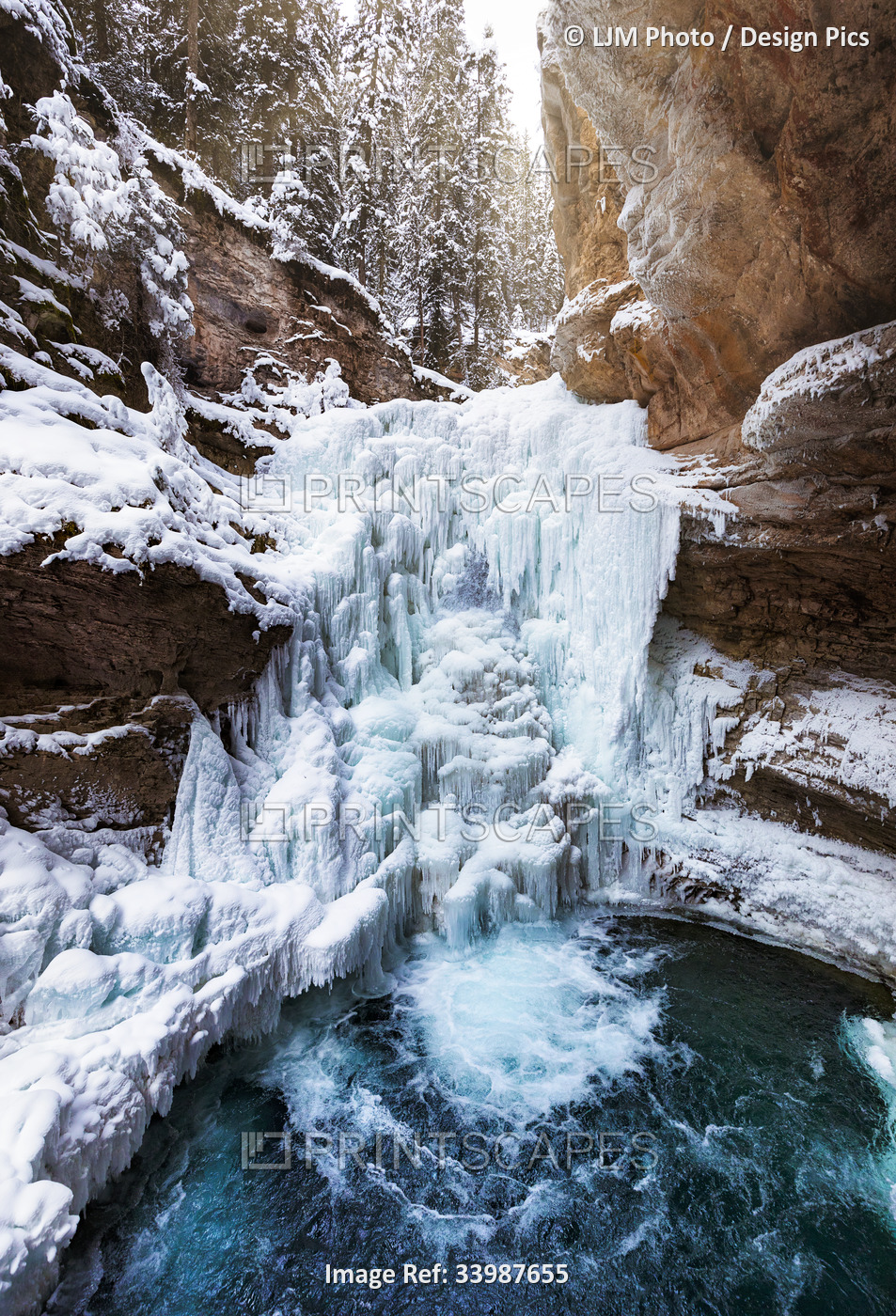 Frozen waterfall and pool at Johnston Canyon during winter in Banff National ...