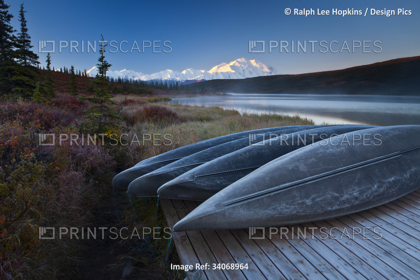 Canoes lined up on a dock at Wonder Lake in front of Mt. McKinley.