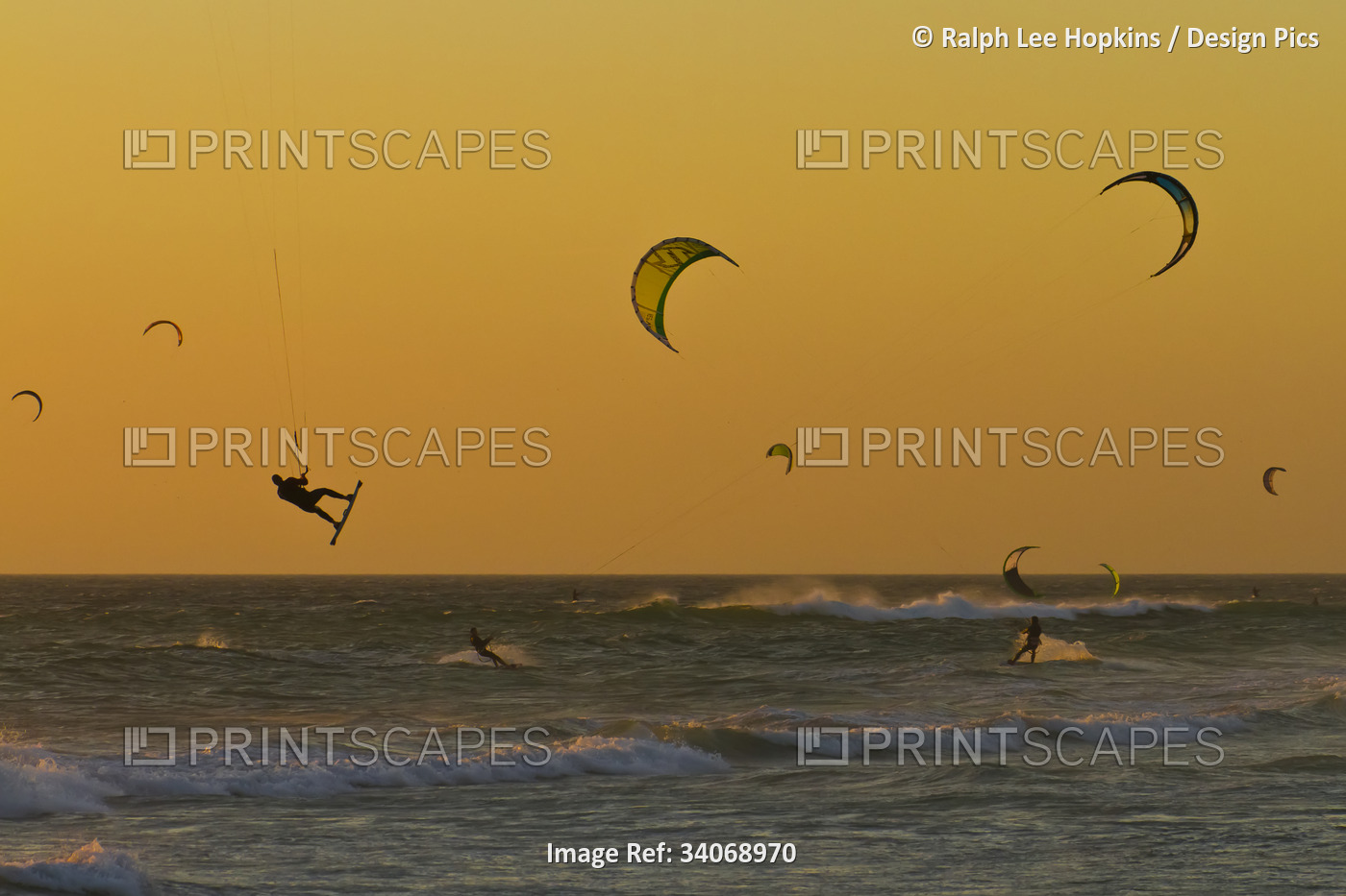 Kite surfers at sunset.