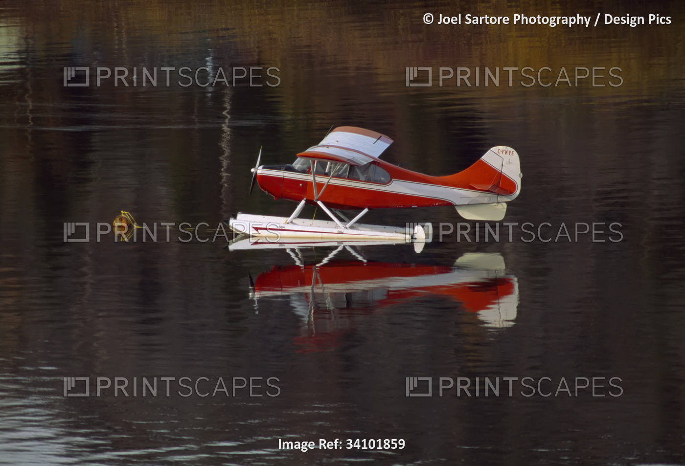 Floatplane and it's mirror image reflected on a glacial lake; Yellowknife, ...
