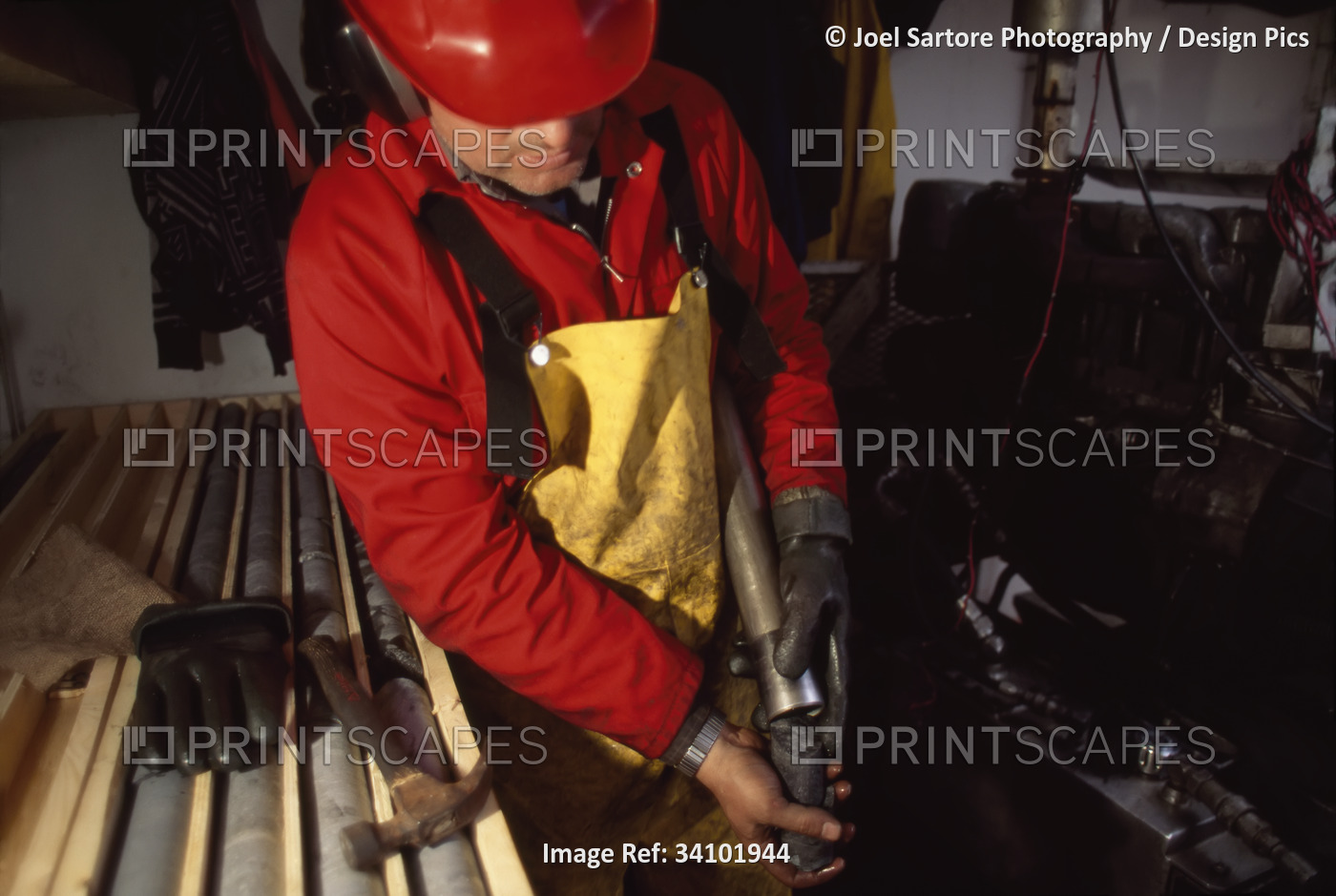Looking for diamonds, a driller gets a core sample from a drill pipe; ...