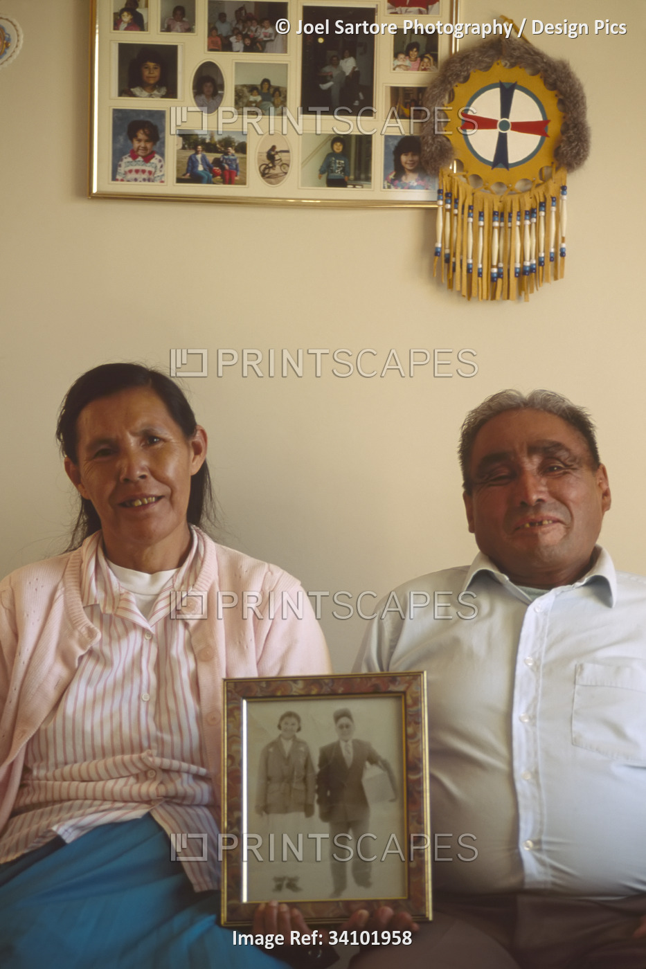 Native Dene couple with family photos, near Yellowknife, NWT, Canada; Northwest ...