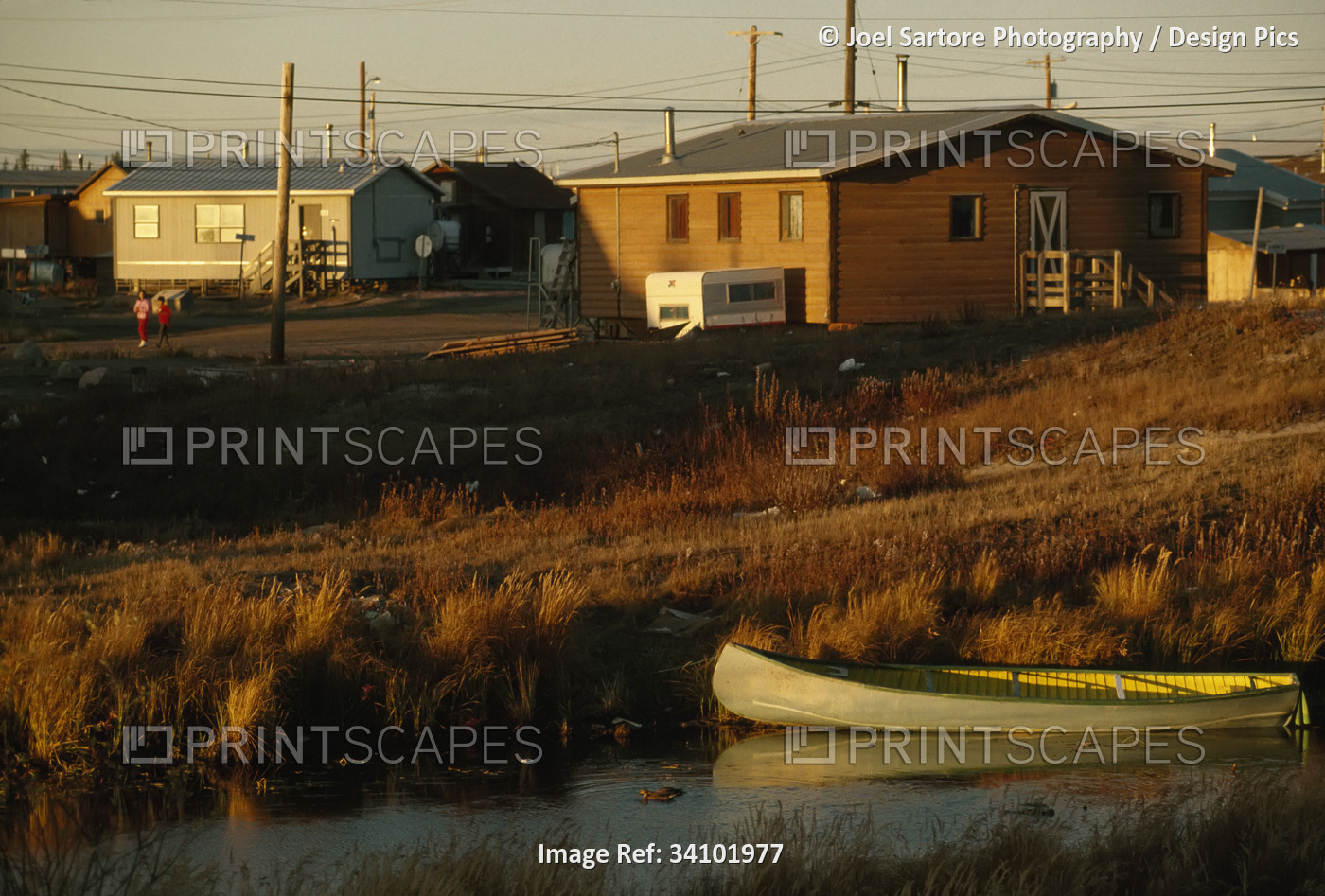 Canoe moored along the shore near a Dene village, near Yellowknife, NWT, ...
