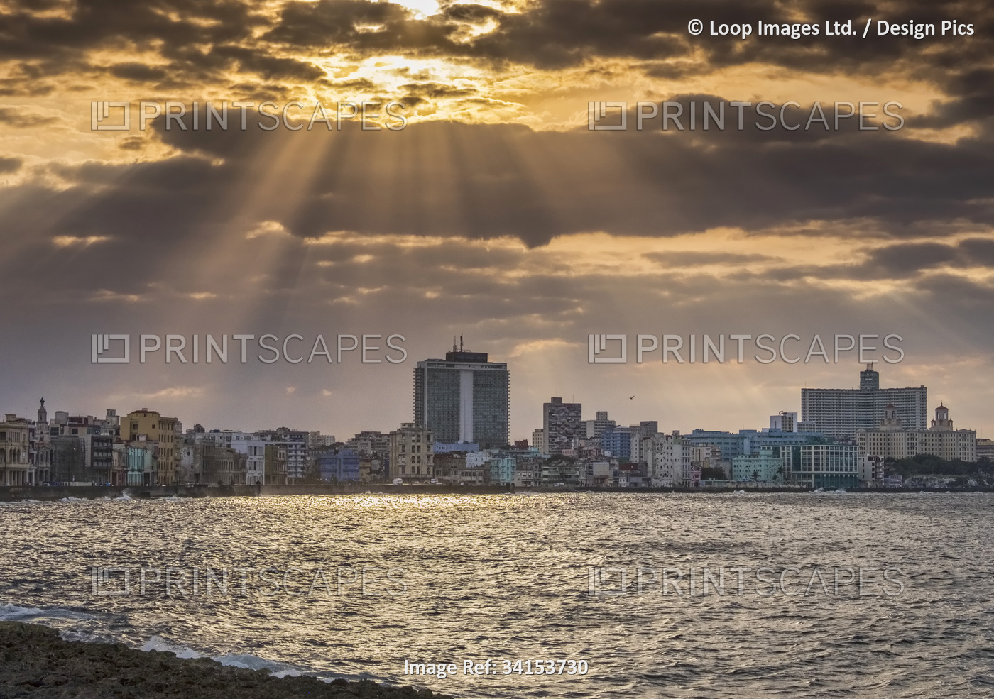 Sunburst and crepuscular rays over The Malecon in Havana.