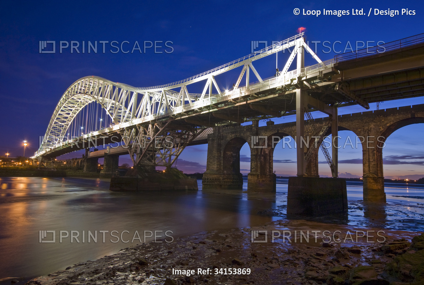 The Runcorn and Widnes transporter bridge over the River Mersey at night.