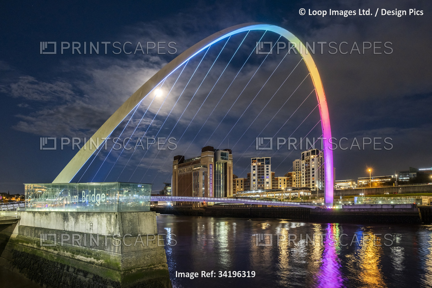 The Gateshead Millennium Bridge over the River Tyne at night.