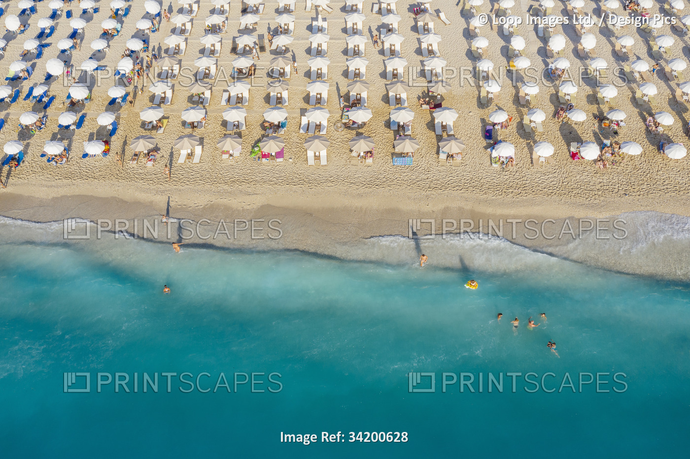 An aerial view of Kathisma beach in Lefkada with people enjoying the deep blue ...