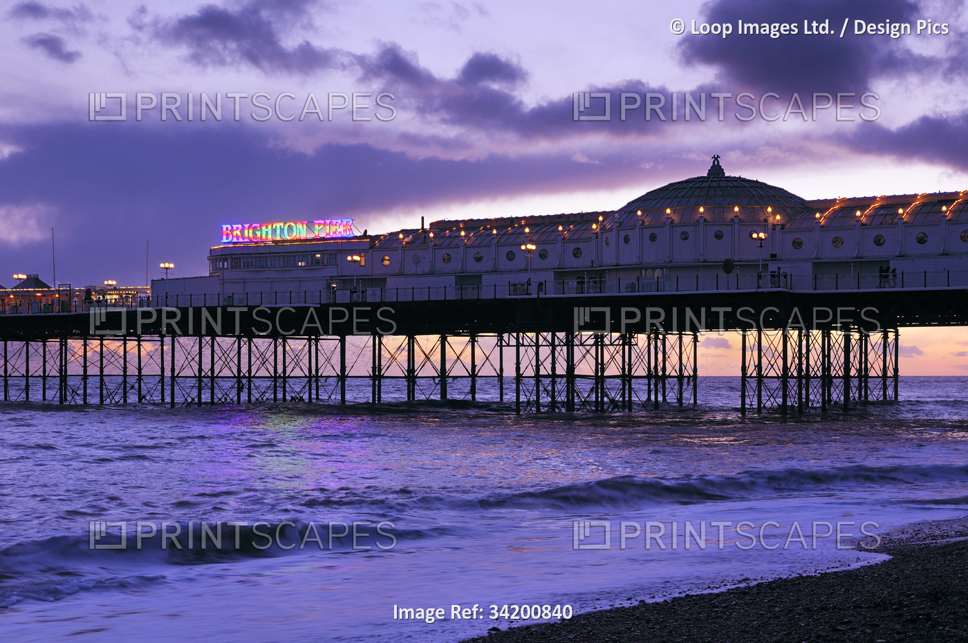 Brighton Palace Pier seen at sunset as dusk begins to fall.
