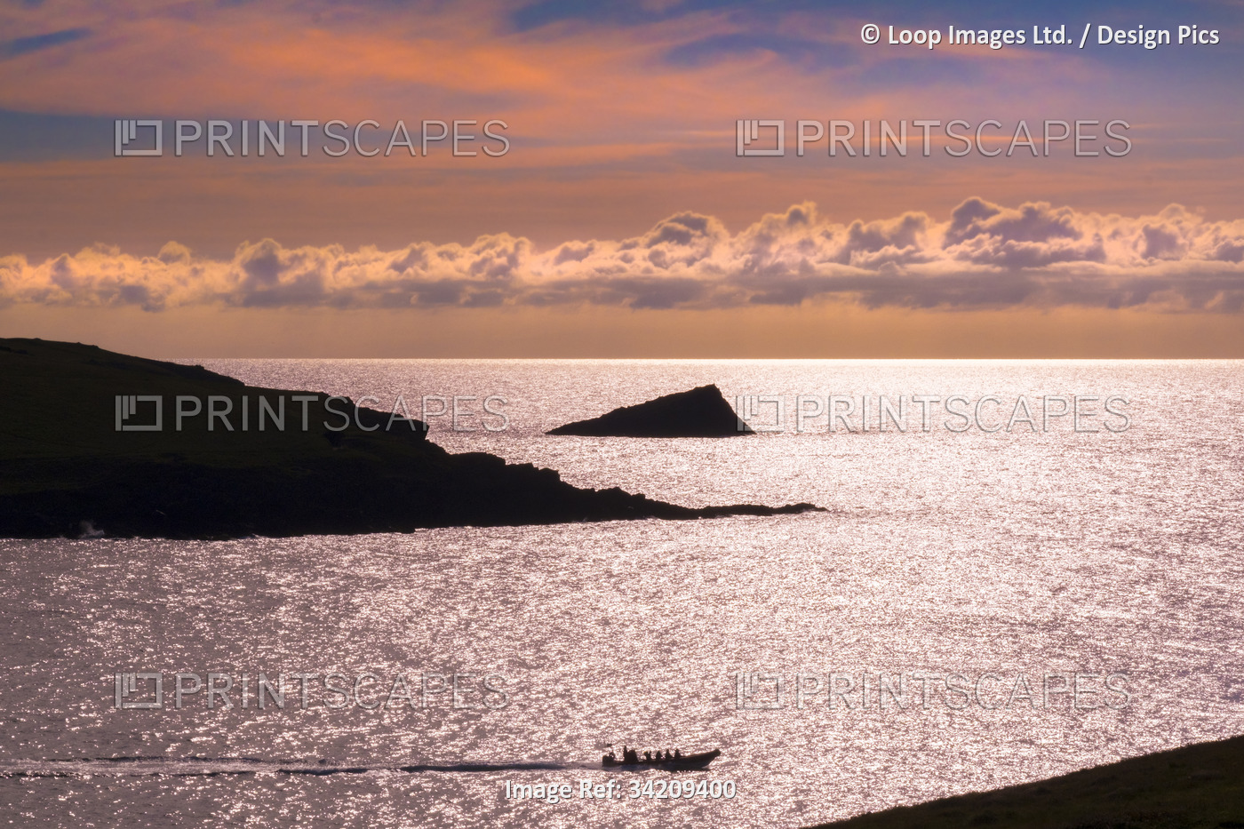 A tourist power boat sailing past Pentire Point West and The Chick an ...