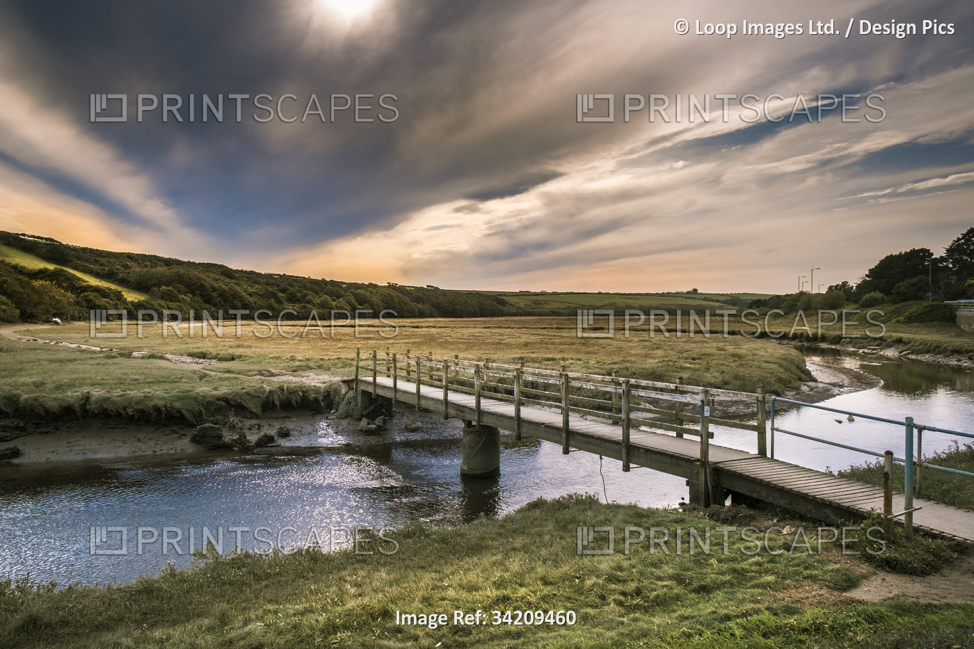 Early evening sunlight over the River Gannel at low tide in Newquay in Cornwall.