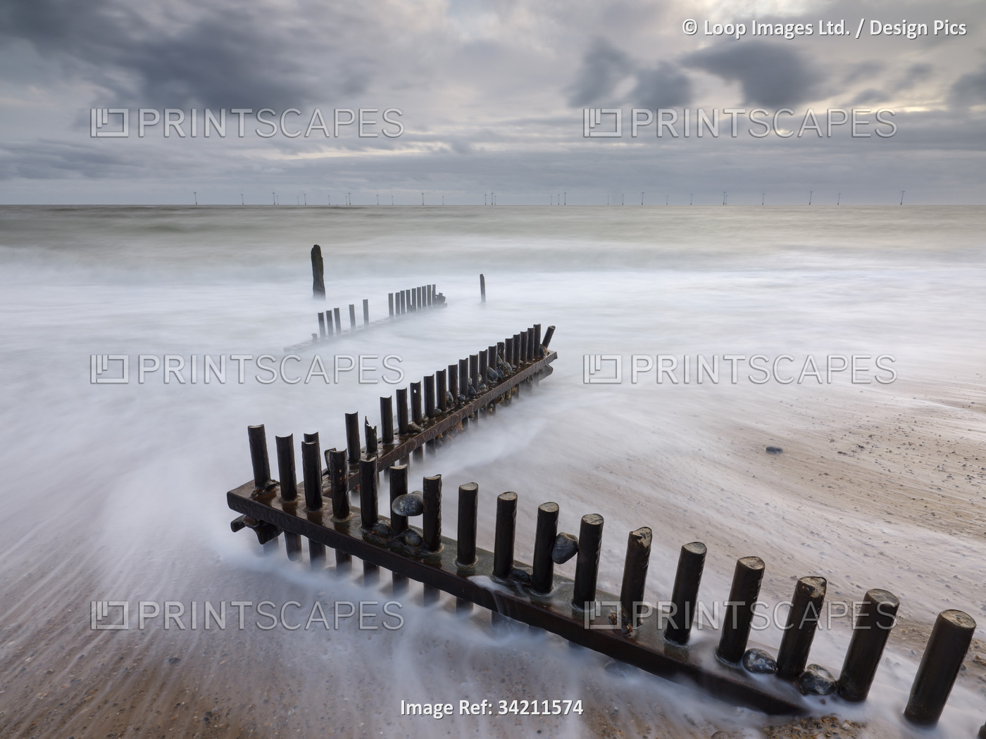 Waves washing over a wooden groyne at Caister-on-Sea in Norfolk.