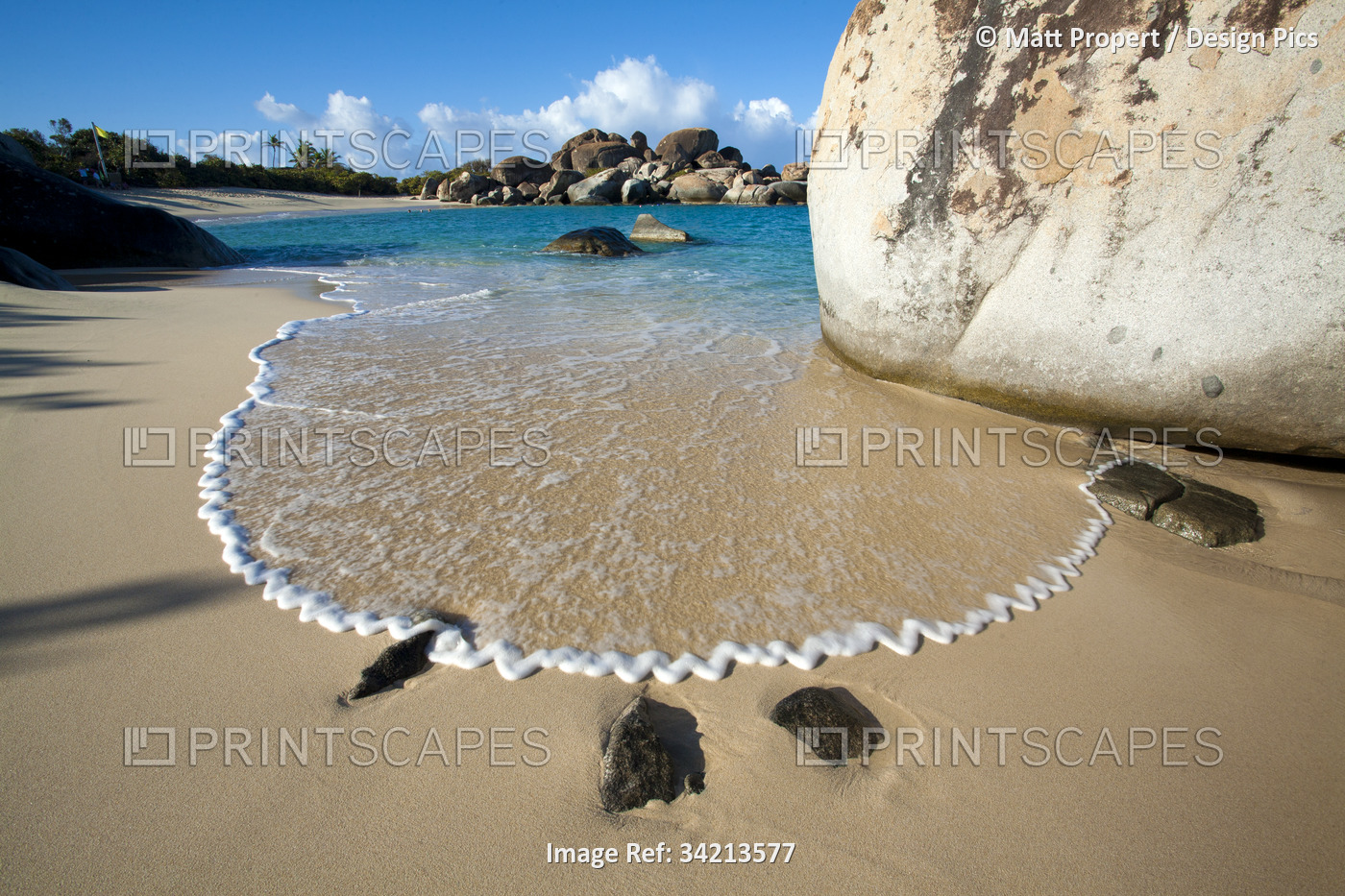 Stunning view of the sandy beach with surf forming a zigzag pattern in the foam ...