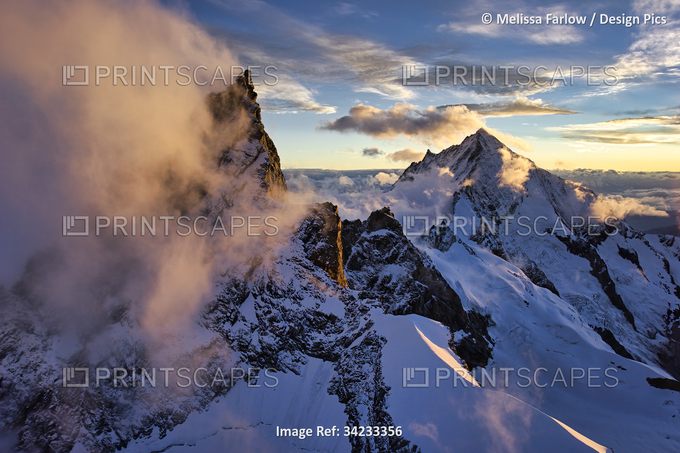 Morning fog rises from peaks in the Alps near the Matterhorn; Zermatt, ...