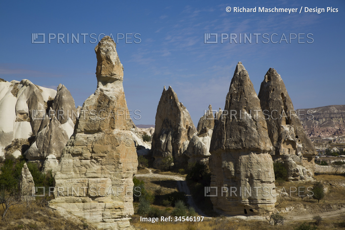 Cave Houses carved into the volcanic rock formations, Fairy Chimneys, against a ...