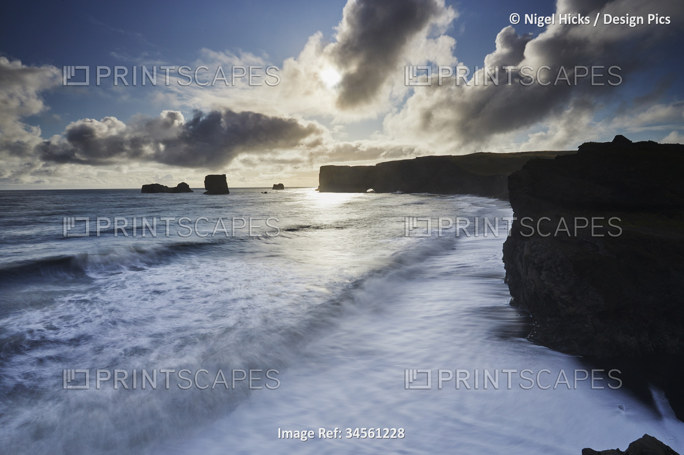 Scenic view of the coastline of Dyrholaey Island with the surf and rugged ...