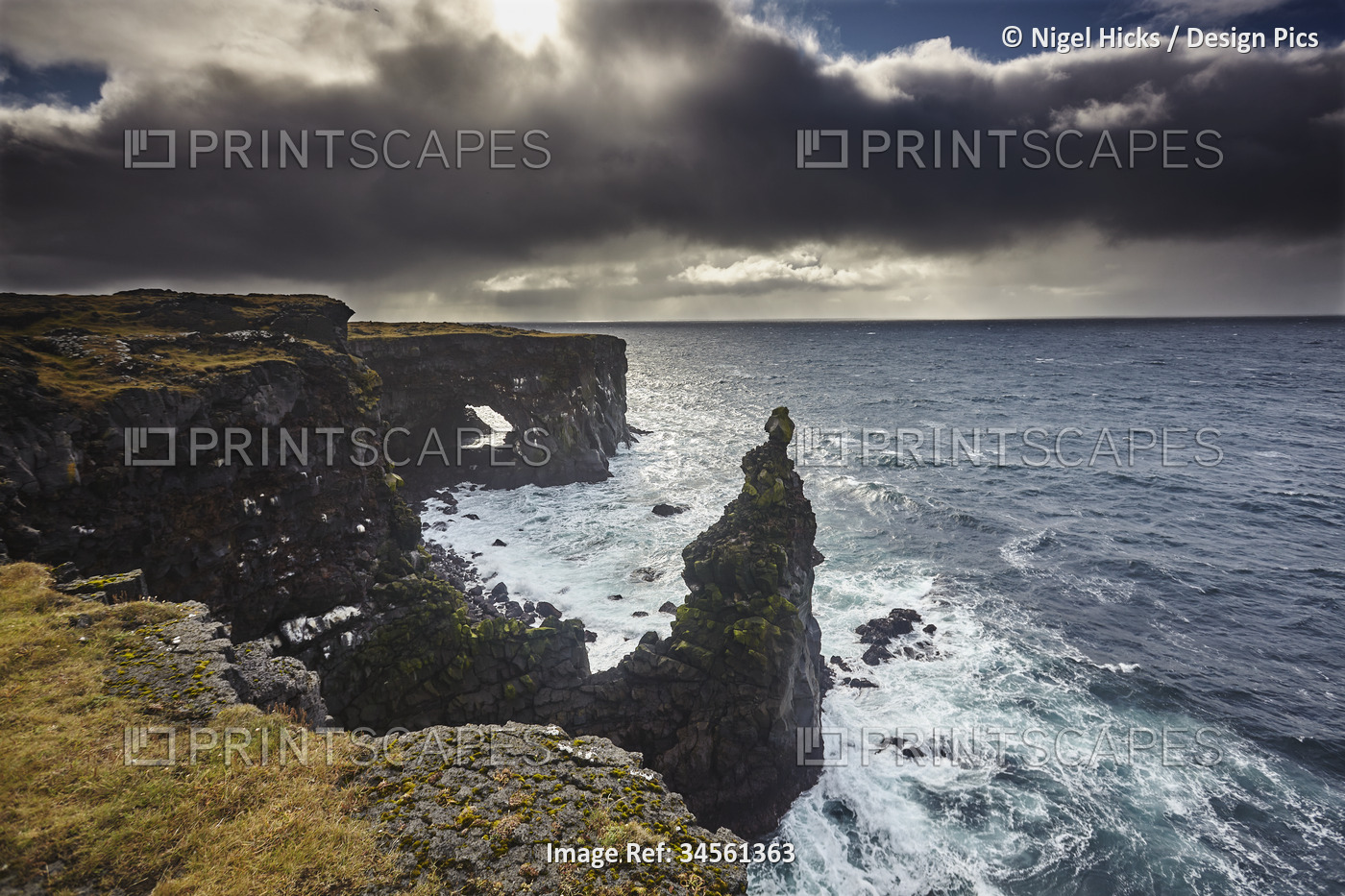Lava cliffs at Skalasnagi with dramatic storm clouds, at the northwestern tip ...