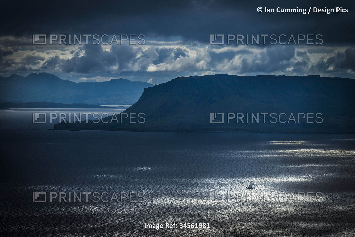Small yacht sailing past Eigg Island in the Scottish Inner Hebrides; Scotland