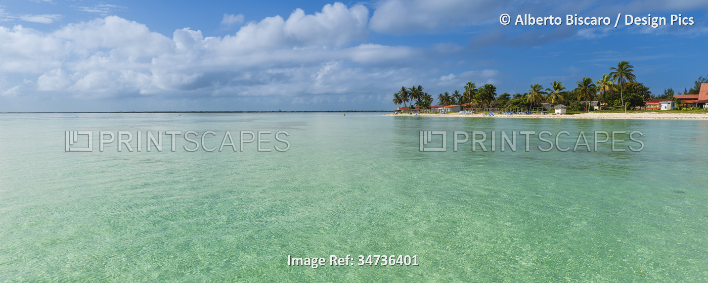 View of a seaside resort town and the turquoise water off the beach in Cayo ...