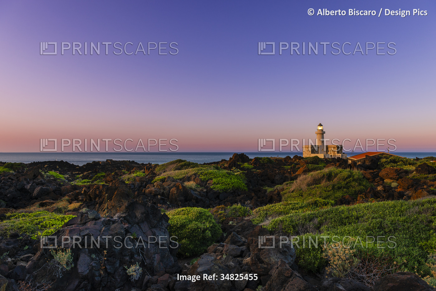 Scenic view of the coastal landscape with the Lighthouse at Faro Di Punta ...